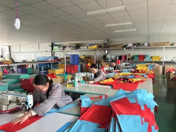 Machinists stitching coloured cover panels for soft sports products